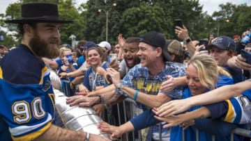 ST LOUIS, MO - JUNE 15: Fans reacts to Ryan O'Reilly #90 of the St. Louis Blues as he holds the Stanley Cup during the St Louis Blues Victory Parade and Rally after winning the 2019 Stanley Cup Final on June 15, 2019 in St Louis, Missouri. (Photo by Nic Antaya/Getty Images)