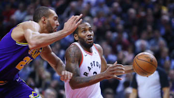 TORONTO, ON - JANUARY 1: Kawhi Leonard #2 of the Toronto Raptors dribbles the ball as Rudy Gobert #27 of the Utah Jazz defends during the first half of an NBA game at Scotiabank Arena on January 1, 2019 in Toronto, Canada. NOTE TO USER: User expressly acknowledges and agrees that, by downloading and or using this photograph, User is consenting to the terms and conditions of the Getty Images License Agreement. (Photo by Vaughn Ridley/Getty Images)