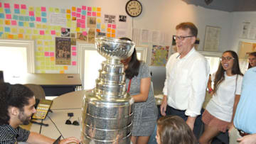 Capital Gazette editor Rick Hutzell, right, checks out the Stanley Cup. The Washington Capitals' equipment manager Craig Lydig brought the NHL Stanley Cup to the temporary Capital Gazette offices in Annapolis, Md. on Tuesday, July 3, 2018. (Paul W. Gillespie/Baltimore Sun Media Group/TNS via Getty Images)