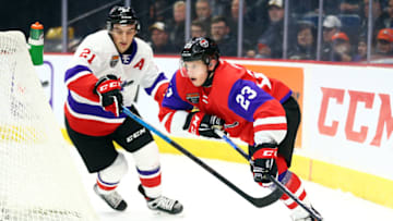 HAMILTON, ON - JANUARY 16: Marco Rossi #23 of Team Red and Ryan O'Rourke #21 of Team White battle for the puck during the second period of the 2020 CHL/NHL Top Prospects Game at FirstOntario Centre on January 16, 2020 in Hamilton, Canada. (Photo by Vaughn Ridley/Getty Images)