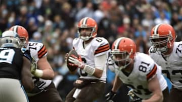 Dec 21, 2014; Charlotte, NC, USA; Cleveland Browns quarterback Brian Hoyer (6) looks to pass as guard Joel Bitonio (75) and tight end Jim Dray (81) and tackle Joe Thomas (73) block an Carolina Panthers defensive tackle Kawann Short (99) defends in the third quarter at Bank of America Stadium. Mandatory Credit: Bob Donnan-USA TODAY Sports