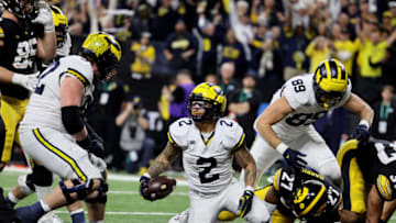 Dec 2, 2023; Indianapolis, IN, USA; Michigan Wolverines running back Blake Corum (2) celebrates with Michigan Wolverines offensive lineman Karsen Barnhart (52) after scoring a touchdown during the second half of the Big Ten Championship game against the Iowa Hawkeyes at Lucas Oil Stadium. Mandatory Credit: Trevor Ruszkowski-USA TODAY Sports
