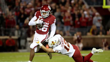 Nov 9, 2019; Norman, OK, USA; Oklahoma Sooners running back Kennedy Brooks (26) runs as Iowa State Cyclones defensive back Greg Eisworth (12) defends during the first quarter at Gaylord Family - Oklahoma Memorial Stadium. Mandatory Credit: Kevin Jairaj-USA TODAY Sports