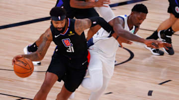 LAKE BUENA VISTA, FLORIDA - AUGUST 30: Marcus Morris Sr. #31 of the LA Clippers drives past Dorian Finney-Smith #10 of the Dallas Mavericks in Game Six of the Western Conference First Round during the 2020 NBA Playoffs at AdventHealth Arena at ESPN Wide World Of Sports Complex on August 30, 2020 in Lake Buena Vista, Florida. NOTE TO USER: User expressly acknowledges and agrees that, by downloading and or using this photograph, User is consenting to the terms and conditions of the Getty Images License Agreement. (Photo by Kevin C. Cox/Getty Images)