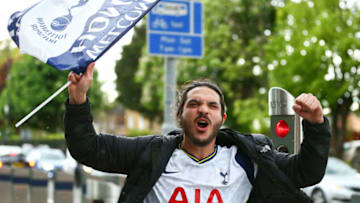 LONDON, ENGLAND - MAY 19: A fan poses with a flag outside of Tottenham Hotspur Stadium ahead of the Premier League match between Tottenham Hotspur and Aston Villa at Tottenham Hotspur Stadium on May 19, 2021 in London, England. A limited number of fans will be allowed into Premier League stadiums as Coronavirus restrictions begin to ease in the UK during the COVID-19 pandemic. (Photo by Jacques Feeney/Getty Images)