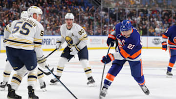 Nov 2, 2019; Buffalo, NY, USA; New York Islanders left wing Otto Koivula (21) shoots the puck as Buffalo Sabres defenseman Rasmus Ristolainen (55) defends during the first period at KeyBank Center. Mandatory Credit: Timothy T. Ludwig-USA TODAY Sports
