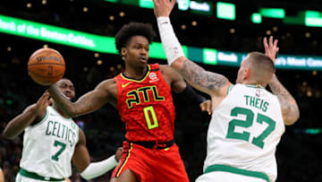 BOSTON, MASSACHUSETTS - JANUARY 03: Brandon Goodwin #0 of the Atlanta Hawks makes a pass around Daniel Theis #27 of the Boston Celtics at TD Garden on January 03, 2020 in Boston, Massachusetts. (Photo by Maddie Meyer/Getty Images)