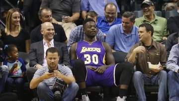 Nov 1, 2016; Indianapolis, IN, USA; Los Angeles Lakers forward Julius Randle (30) sits down in the front row with the fans while the malfunctioning shot clock is worked on in the first quarter against the Indiana Pacers at Bankers Life Fieldhouse. Mandatory Credit: Brian Spurlock-USA TODAY Sports