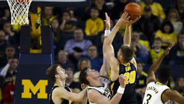 Mar 5, 2016; Ann Arbor, MI, USA; Iowa Hawkeyes forward Jarrod Uthoff (20) shoots over Michigan Wolverines forward Ricky Doyle (32) in the first half at Crisler Center. Mandatory Credit: Rick Osentoski-USA TODAY Sports