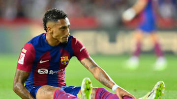 Barcelona's Brazilian forward #11 Raphinha sits on the field during the Spanish Liga football match between FC Barcelona and Sevilla FC at the Estadi Olimpic Lluis Companys in Barcelona on September 29, 2023. (Photo by Pau BARRENA / AFP) (Photo by PAU BARRENA/AFP via Getty Images)