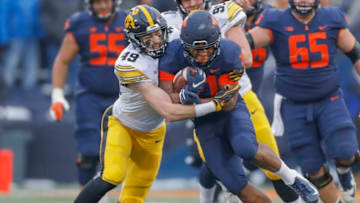 CHAMPAIGN, IL - NOVEMBER 17: Ra'Von Bonner #21 of the Illinois Fighting Illini runs the ball as Nick Niemann #49 of the Iowa Hawkeyes makes the stop at Memorial Stadium on November 17, 2018 in Champaign, Illinois. (Photo by Michael Hickey/Getty Images)