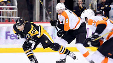 PITTSBURGH, PA - NOVEMBER 27: Pittsburgh Penguins Left Wing Carl Hagelin (62) moves the puck as Philadelphia Flyers Defenseman Travis Sanheim (6) defends during the second period in the NHL game between the Pittsburgh Penguins and the Philadelphia Flyers on November 27, 2017, at PPG Paints Arena in Pittsburgh, PA. The Penguins defeated the Flyers 5-4 in overtime. (Photo by Jeanine Leech/Icon Sportswire via Getty Images)