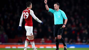 LONDON, ENGLAND - DECEMBER 16: Granit Xhaka of Arsenal is shown a yellow card by referee Stuart Attwell during the Premier League match between Arsenal and Newcastle United at Emirates Stadium on December 16, 2017 in London, England. (Photo by Julian Finney/Getty Images)