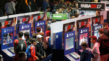 PARIS, FRANCE - OCTOBER 27: Gamers play the video game "WWE 2K17" developed by Visual Concepts and Yuke's and published by 2K Sports during the "Paris Games Week" on October 27, 2016 in Paris, France. "Paris Games Week is an international trade fair for video games to be held from October 26 to October 31, 2016. (Photo by Chesnot/Getty Images)