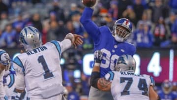 Dec 20, 2015; East Rutherford, NJ, USA; New York Giants defensive end Jason Pierre-Paul (90) blocks Carolina Panthers quarterback Cam Newton (1) pass during the fourth quarter at MetLife Stadium. Carolina Panthers defeat the New York Giants 38-35. Mandatory Credit: Jim O