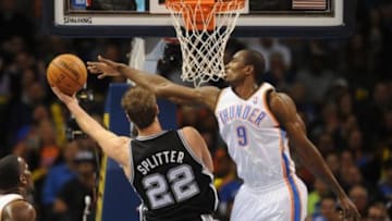 Nov 27, 2013; Oklahoma City, OK, USA; Oklahoma City Thunder power forward Serge Ibaka (9) attempts to block a shot attempt by San Antonio Spurs center Tiago Splitter (22) during the second quarter at Chesapeake Energy Arena. Mandatory Credit: Mark D. Smith-USA TODAY Sports