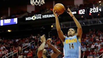 HOUSTON, TX - APRIL 05: Gary Harris #14 of the Denver Nuggets shoots the ball defended by Nene Hilario #42 of the Houston Rockets in the second half at Toyota Center on April 5, 2017 in Houston, Texas. NOTE TO USER: User expressly acknowledges and agrees that, by downloading and or using this photograph, User is consenting to the terms and conditions of the Getty Images License Agreement. (Photo by Tim Warner/Getty Images)