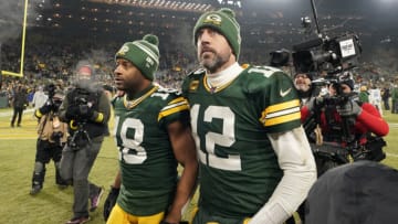 Aaron Rodgers #12 and Randall Cobb #18 of the Green Bay Packers walk off the field after losing to the Detroit Lions at Lambeau Field on January 08, 2023 in Green Bay, Wisconsin. (Photo by Patrick McDermott/Getty Images)