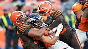 DENVER, CO - NOVEMBER 3: Phillip Lindsay #30 of the Denver Broncos is tackled by two defenders during a game against the Cleveland Browns at Broncos Stadium at Mile High on November 3, 2019 in Denver, Colorado. The Broncos defeated the Browns 24-19. (Photo by Wesley Hitt/Getty Images)