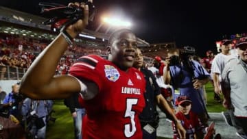 Dec 28, 2013; Orlando, FL, USA; Louisville Cardinals quarterback Teddy Bridgewater (5) celebrates after the Russell Athletic Bowl against the Miami Hurricanes at Florida Citrus Bowl Stadium. Mandatory Credit: David Manning-USA TODAY Sports
