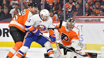 Feb 6, 2023; Philadelphia, Pennsylvania, USA; Philadelphia Flyers goaltender Carter Hart (79) makes a save as New York Islanders left wing Zach Parise (11) battles with defenseman Rasmus Ristolainen (55) during the third period at Wells Fargo Center. Mandatory Credit: Eric Hartline-USA TODAY Sports