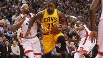 Feb 26, 2016; Toronto, Ontario, CAN; Cleveland Cavaliers forward LeBron James (23) dribbles the ball between Toronto Raptors forward James Johnson (3) and forward Terrence Ross (31) during the first half at the Air Canada Centre. Mandatory Credit: John E. Sokolowski-USA TODAY Sports