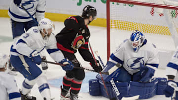Dec 11, 2021; Ottawa, Ontario, CAN; Tampa Bay Lightning goalie Brian Elliott (1) makes a save in front of Ottawa Senators left wing Alex Formenton (10) in the third period at the Canadian Tire Centre. Mandatory Credit: Marc DesRosiers-USA TODAY Sports