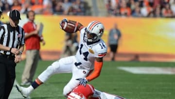 Jan 1, 2015; Tampa, FL, USA; Auburn Tigers quarterback Nick Marshall (14) gets tackled by Wisconsin Badgers defensive back Tanner McEvoy (11) in the second half of the 2015 Outback Bowl at Raymond James Stadium. The Wisconsin Badgers defeated the Auburn Tigers 34-31 in overtime. Mandatory Credit: Jonathan Dyer-USA TODAY Sports