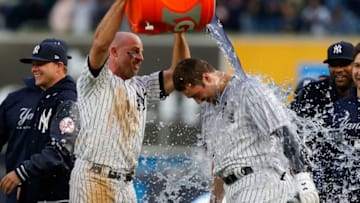 NEW YORK, NY - MAY 12: Brett Gardner #11 (L) of the New York Yankees douses teammate Neil Walker #14 after his eleventh inning game winning base hit against the Oakland Athletics at Yankee Stadium on May 12, 2018 in the Bronx borough of New York City. (Photo by Jim McIsaac/Getty Images)