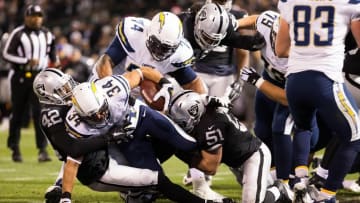 Dec 24, 2015; Oakland, CA, USA; San Diego Chargers running back Donald Brown (34) scores a touchdown between Oakland Raiders strong safety Larry Asante (42) and inside linebacker Ben Heeney (51) during the first quarter at O.co Coliseum. Mandatory Credit: Kelley L Cox-USA TODAY Sports