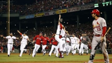 Oct 30, 2013; Boston, MA, USA; Boston Red Sox relief pitcher Koji Uehara (19) reacts with catcher David Ross (3) and teammates after defeating the St. Louis Cardinals in game six of the MLB baseball World Series at Fenway Park. Red Sox won 6-1. Mandatory Credit: Greg M. Cooper-USA TODAY Sports