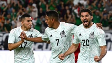 Orbelín Pineda (left) and Luis Romo celebrate with Henry Martín after the latter's goal put América up 1-0 just 43 seconds into the second half. (Photo by PATRICK T. FALLON/AFP via Getty Images)