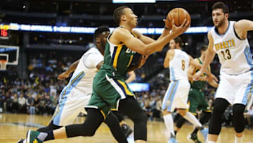 Nov 20, 2016; Denver, CO, USA; Utah Jazz guard Dante Exum (11) drives to the basket against Denver Nuggets center Jusuf Nurkic (23) and Denver Nuggets guard Emmanuel Mudiay (left) during the first half at Pepsi Center. Mandatory Credit: Chris Humphreys-USA TODAY Sports