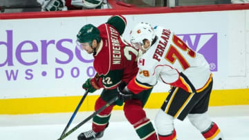 Nov 15, 2016; Saint Paul, MN, USA; Minnesota Wild forward Nino Niederreiter (22) protects the puck from Calgary Flames forward Micheal Ferland (79) during the third period at Xcel Energy Center. The Flames defeated the Wild 1-0. Mandatory Credit: Brace Hemmelgarn-USA TODAY Sports