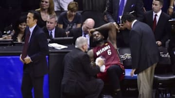 Jun 5, 2014; San Antonio, TX, USA; Miami Heat forward LeBron James (6) reacts on the bench after an injury in the fourth quarter against the San Antonio Spurs in game one of the 2014 NBA Finals at AT&T Center. The Spurs beat the Heat 110-95. Mandatory Credit: Bob Donnan-USA TODAY Sports