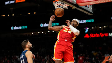 Oct 21, 2021; Atlanta, Georgia, USA; Atlanta Hawks forward Cam Reddish (22) dunks behind Dallas Mavericks forward Maxi Kleber (42) during the second half at State Farm Arena. Mandatory Credit: Dale Zanine-USA TODAY Sports