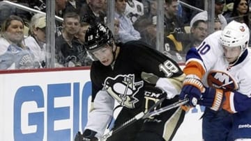 May 1, 2013; Pittsburgh, PA, USA; Pittsburgh Penguins right wing Beau Bennett (19) handles the puck as New York Islanders center Keith Aucoin (10) defends during the second period in game one of the first round of the 2013 Stanley Cup playoffs at CONSOL Energy Center. The Pittsburgh Penguins won 5-0. Mandatory Credit: Charles LeClaire-USA TODAY Sports
