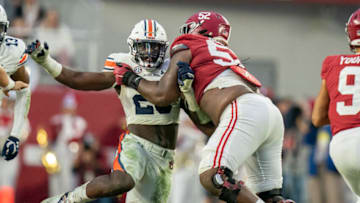 Auburn footballNov 26, 2022; Tuscaloosa, Alabama, USA; Alabama Crimson Tide offensive lineman Tyler Booker (52) blocks Auburn Tigers linebacker Derick Hall (29) during the first half at Bryant-Denny Stadium. Mandatory Credit: Marvin Gentry-USA TODAY Sports