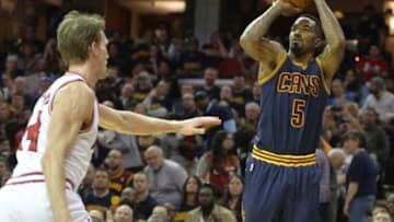 Apr 5, 2015; Cleveland, OH, USA; Cleveland Cavaliers guard J.R. Smith (5) shoots the ball in front of Chicago Bulls forward Mike Dunleavy (34) in the third quarter at Quicken Loans Arena. Mandatory Credit: David Richard-USA TODAY Sports