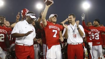 Oct 22, 2011; Houston, TX, USA; Houston Cougars quarterback Case Keenum (7) celebrates breaking the NCAA career all-purpose yard record with head coach Kevin Sumlin (left) and athletic director Mack Rhoades (right) after the game against the Marshall Thundering Herd at Robertson Stadium. Houston won 63-28. Mandatory Credit: Thomas Campbell-US Presswire
