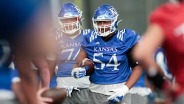 Kansas redshirt sophomore Michael Ford Jr. (54) awaits instructions during practice Tuesday morning in Lawrence.