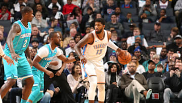 CHARLOTTE, NC - JANUARY 13: Paul George #13 of the Oklahoma City Thunder handles the ball against Kemba Walker #15 of the Charlotte Hornets on January 13, 2018 at Spectrum Center in Charlotte, North Carolina. NOTE TO USER: User expressly acknowledges and agrees that, by downloading and or using this photograph, User is consenting to the terms and conditions of the Getty Images License Agreement. Mandatory Copyright Notice: Copyright 2018 NBAE (Photo by Kent Smith/NBAE via Getty Images)