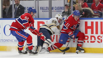 BUFFALO, NY - JANUARY 30: Artturi Lehkonen #62 and Brendan Gallagher #11 of the Montreal Canadiens steal possession of teh puck from Johan Larsson #22 of the Buffalo Sabres from the during the first period of play at the KeyBank Center on January 30, 2020 in Buffalo, New York. (Photo by Nicholas T. LoVerde/Getty Images)