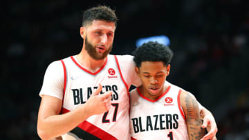 PORTLAND, OREGON - OCTOBER 04: Jusuf Nurkic #27 and Anfernee Simons #1 of the Portland Trail Blazers embrace in the third quarter against the Golden State Warriors during the preseason game at Moda Center on October 04, 2021 in Portland, Oregon. NOTE TO USER: User expressly acknowledges and agrees that, by downloading and or using this photograph, User is consenting to the terms and conditions of the Getty Images License Agreement. (Photo by Abbie Parr/Getty Images)