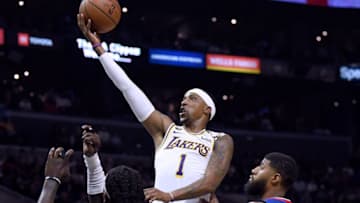 LOS ANGELES, CALIFORNIA - MARCH 08: Kentavious Caldwell-Pope #1 of the Los Angeles Lakers scores on a layup over Paul George #13 and Montrezl Harrell #5 of the LA Clippers during a 112-103 Lakers win at Staples Center on March 08, 2020 in Los Angeles, California. NOTE TO USER: User expressly acknowledges and agrees that, by downloading and or using this photograph, User is consenting to the terms and conditions of the Getty Images License Agreement. (Photo by Harry How/Getty Images)