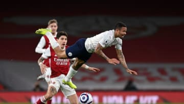 Manchester City's Brazilian striker Gabriel Jesus (R) is felled in the tackle by Arsenal's Spanish defender Hector Bellerin (L) during the English Premier League football match between Arsenal and Manchester City at the Emirates Stadium in London on February 21, 2021. (Photo by Shaun Botterill / POOL / AFP) / RESTRICTED TO EDITORIAL USE. No use with unauthorized audio, video, data, fixture lists, club/league logos or 'live' services. Online in-match use limited to 120 images. An additional 40 images may be used in extra time. No video emulation. Social media in-match use limited to 120 images. An additional 40 images may be used in extra time. No use in betting publications, games or single club/league/player publications. / (Photo by SHAUN BOTTERILL/POOL/AFP via Getty Images)