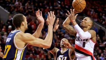 Feb 3, 2015; Portland, OR, USA; Portland Trail Blazers guard Damian Lillard (0) shoots over Utah Jazz center Rudy Gobert (27) during the fourth quarter at the Moda Center. Mandatory Credit: Craig Mitchelldyer-USA TODAY Sports