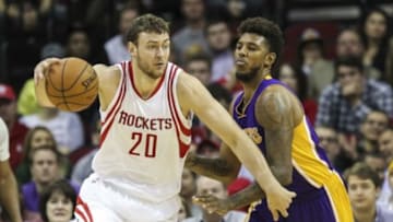 Dec 12, 2015; Houston, TX, USA; Houston Rockets forward Donatas Motiejunas (20) drives the ball as Los Angeles Lakers forward Nick Young (0) defends during the fourth quarter at Toyota Center. Mandatory Credit: Troy Taormina-USA TODAY Sports