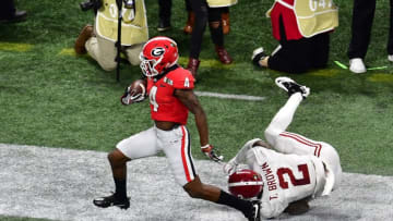 ATLANTA, GA - JANUARY 08: Mecole Hardman #4 of the Georgia Bulldogs runs with a catch for a touchdown against Tony Brown #2 of the Alabama Crimson Tide in the CFP National Championship presented by AT&T at Mercedes-Benz Stadium on January 8, 2018 in Atlanta, Georgia. (Photo by Scott Cunningham/Getty Images)