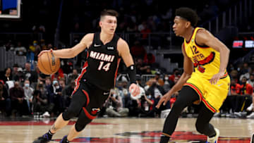 Jan 12, 2022; Atlanta, Georgia, USA; Miami Heat guard Tyler Herro (14) drives against Atlanta Hawks forward De'Andre Hunter (12) during the second quarter at State Farm Arena. Mandatory Credit: Jason Getz-USA TODAY Sports